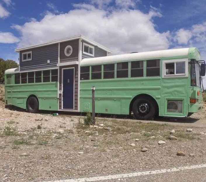 Family of 7 turns bus into charming home with loft and Dad proudly shows off the inside