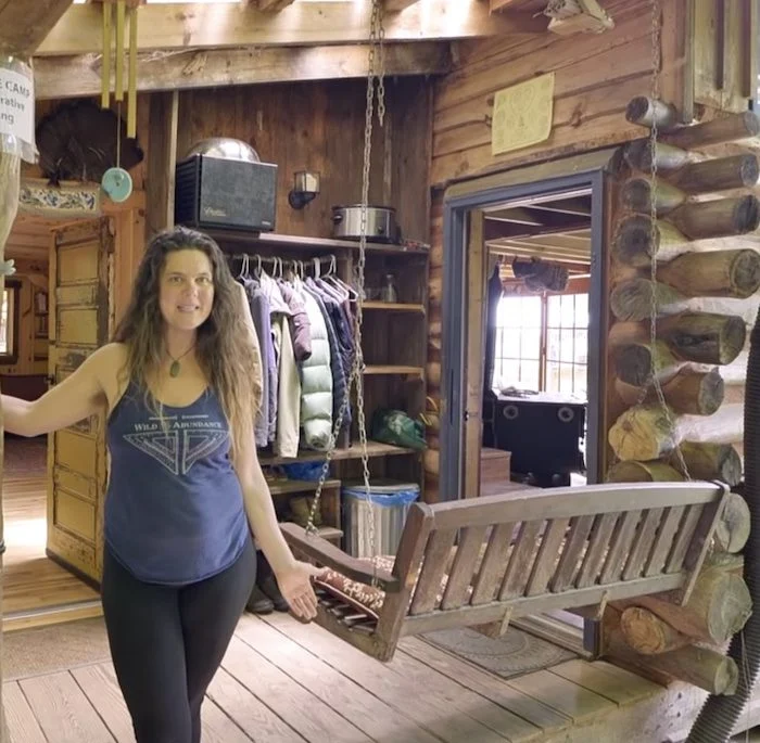 Woman gives tour of beautiful log tiny cabin she built herself on $5k budget