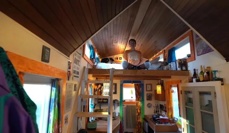 Woman gives a tour of her artsy tiny home built set designer mom’s help
